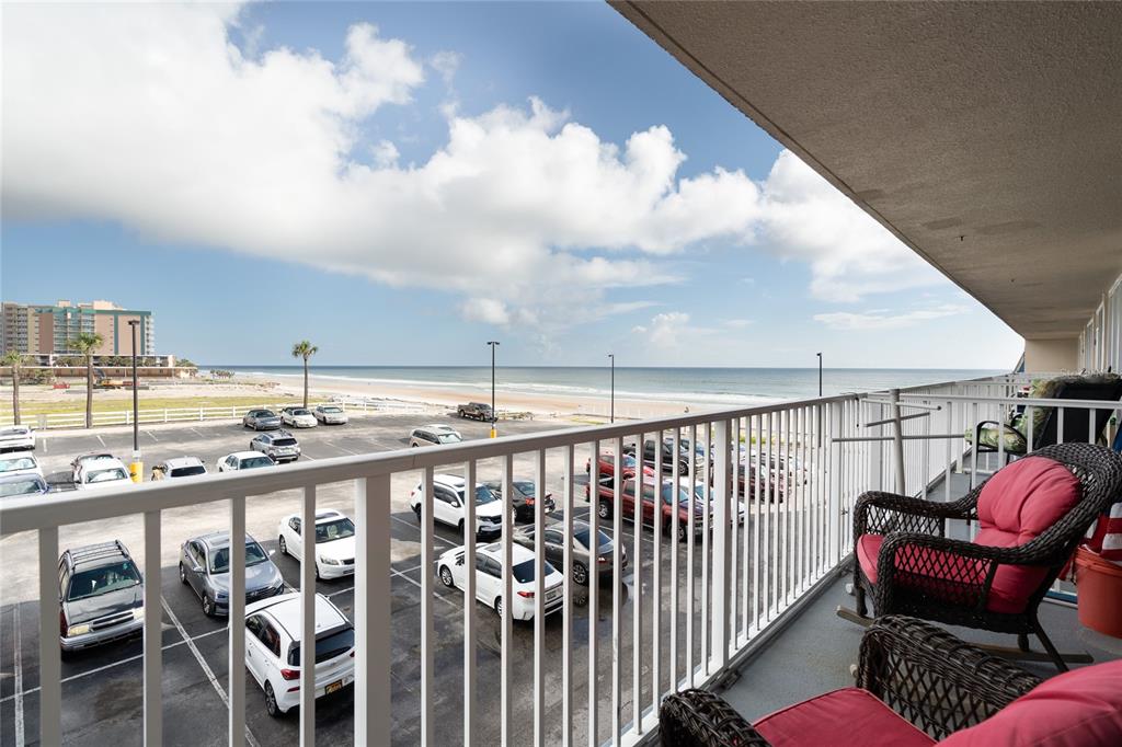 a balcony with a table and chairs