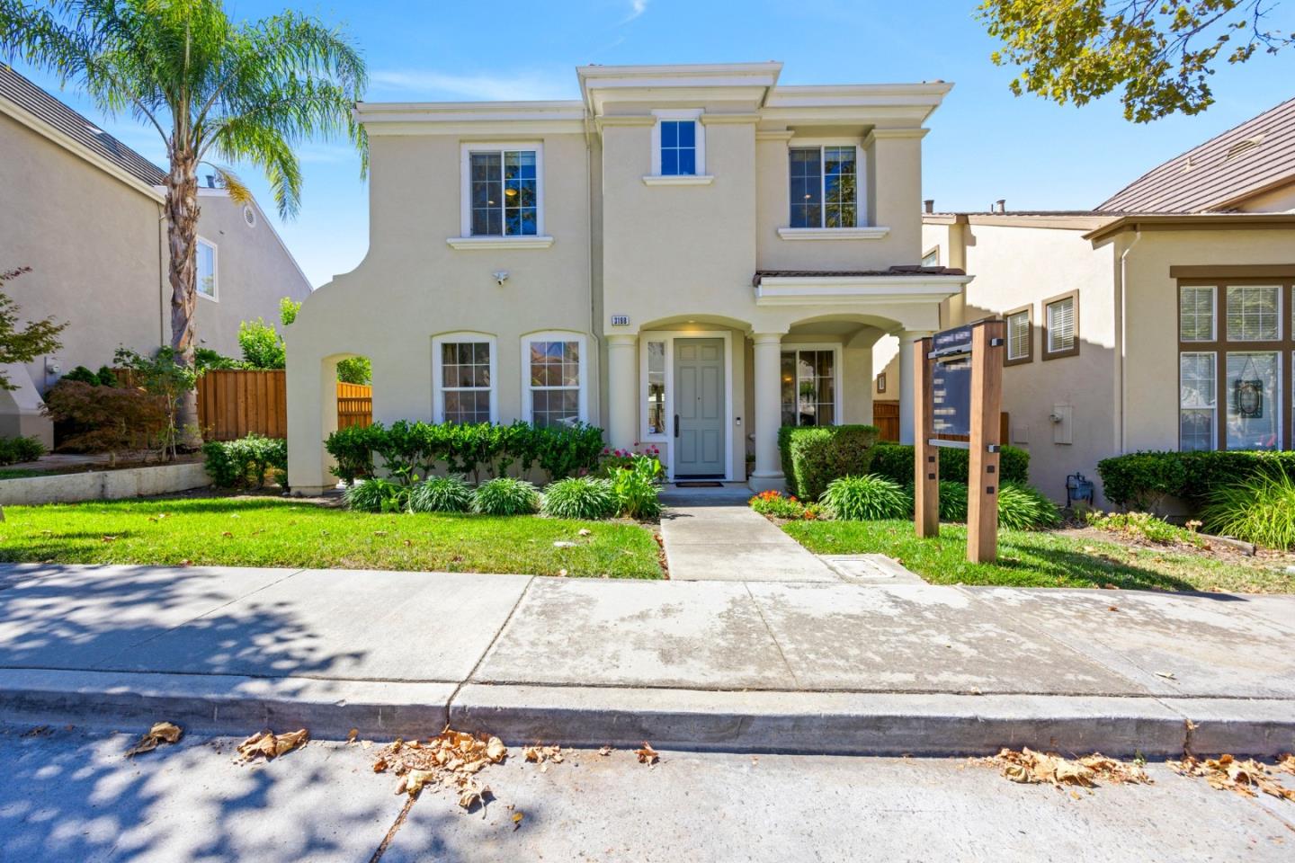 a front view of a house with a yard and a garage