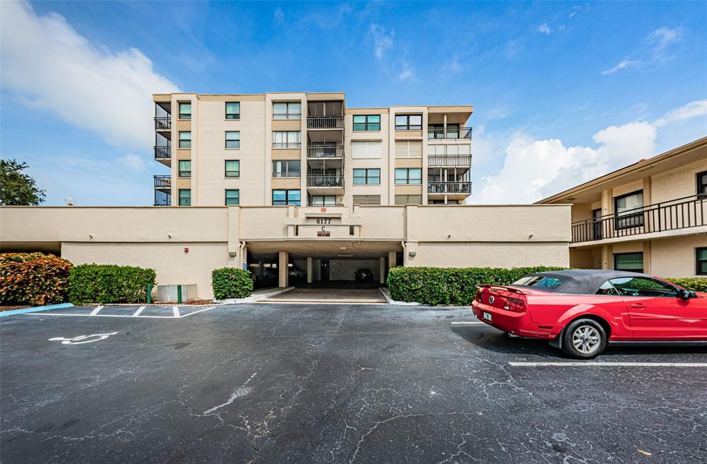 a front view of a building with parking