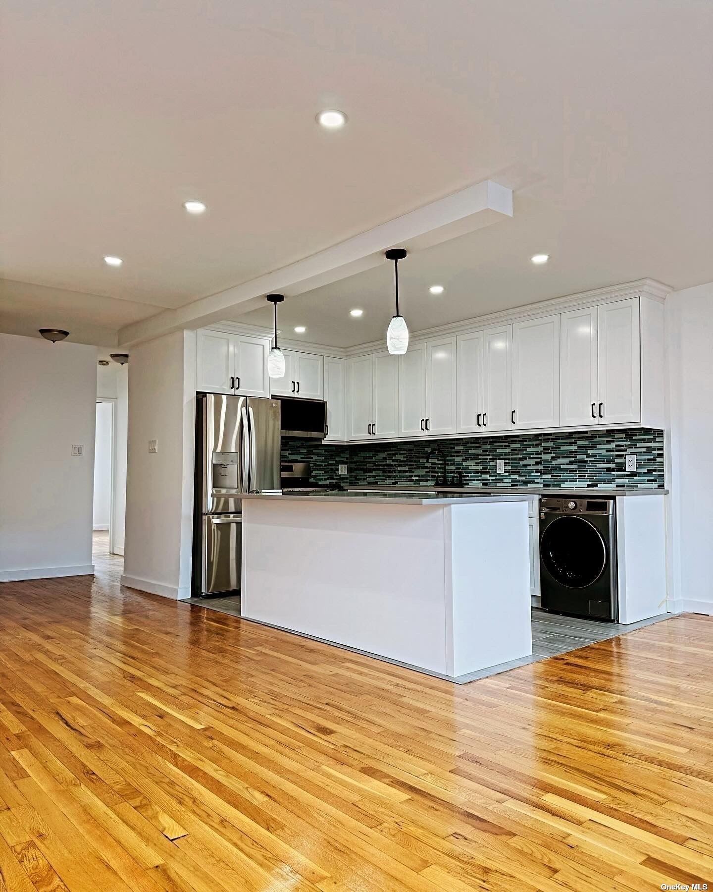 a kitchen with stainless steel appliances granite countertop a refrigerator and a stove top oven