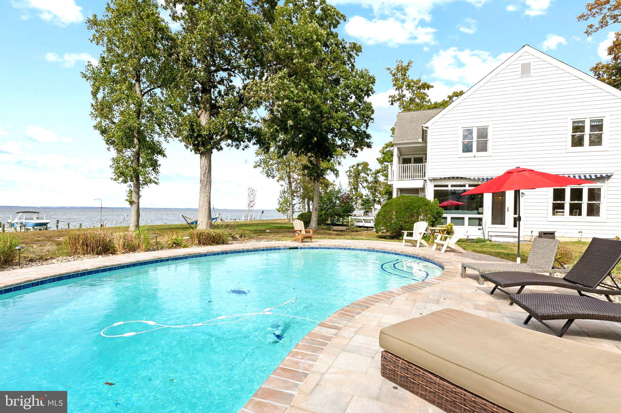 a view of swimming pool with outdoor seating and city view