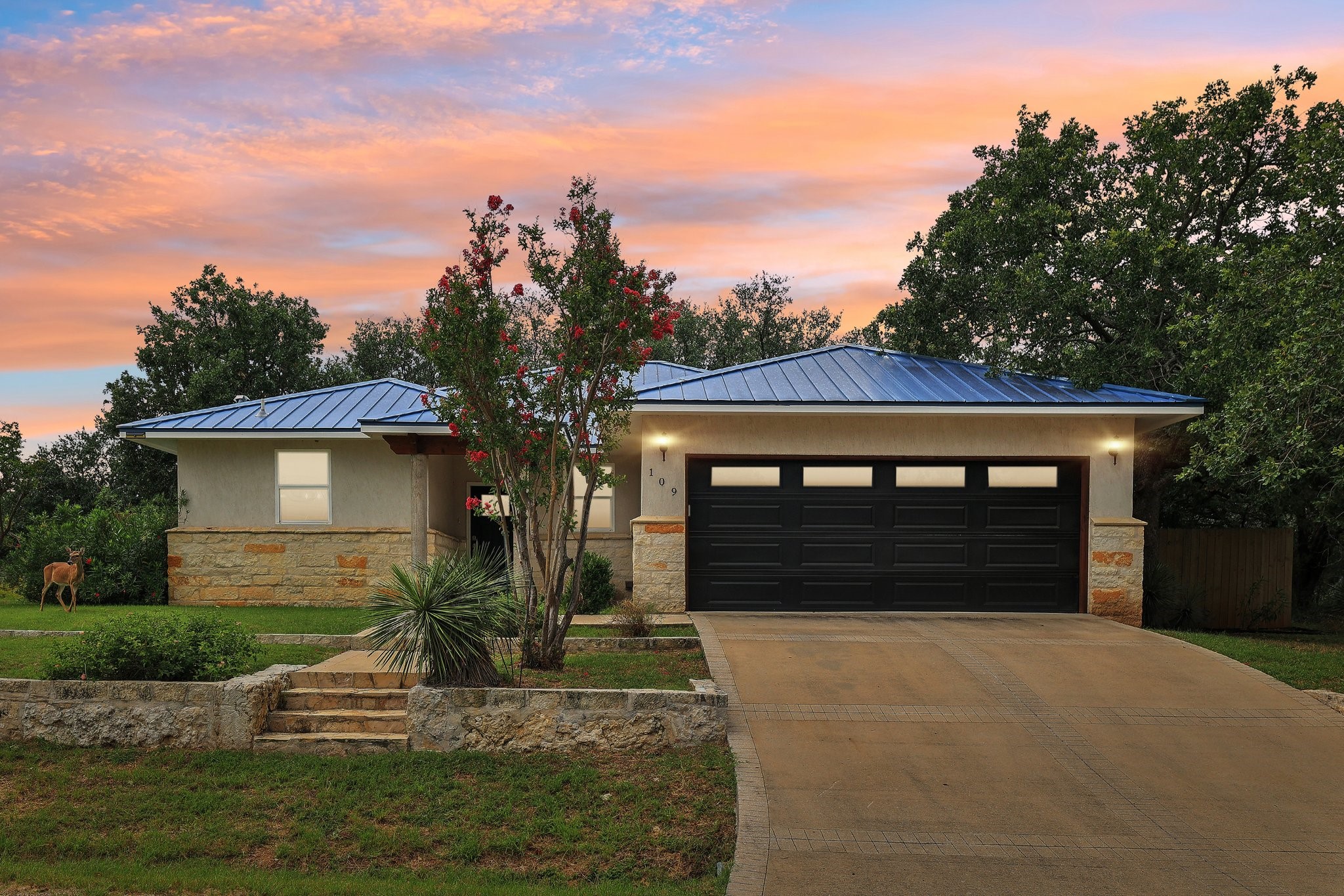 a front view of a house with a yard and garage