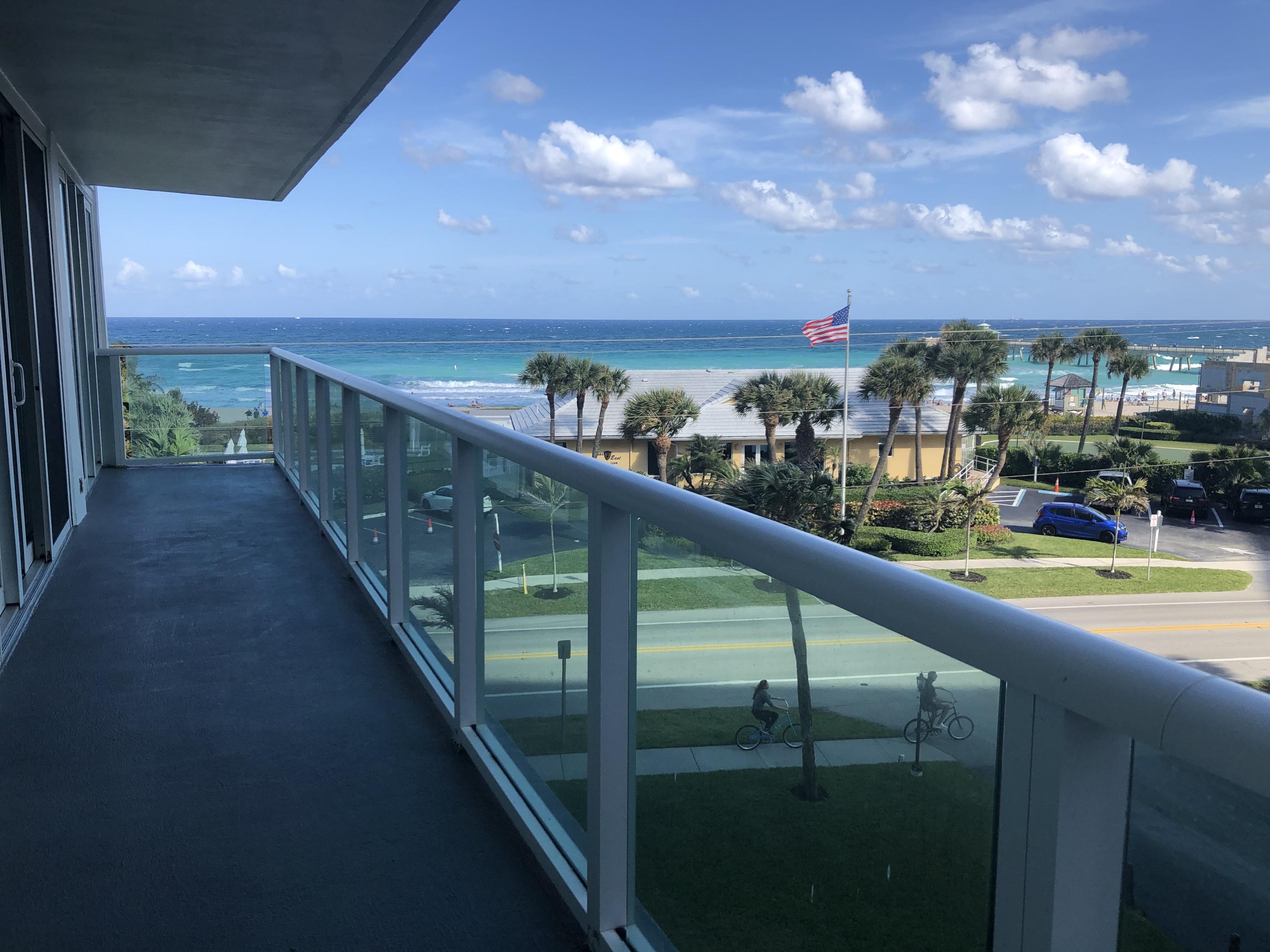 a view of city and swimming pool from a balcony