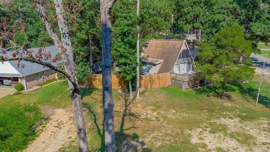 an aerial view of a house with garden space and a tree