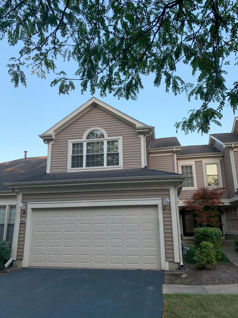 a front view of a house with a garage