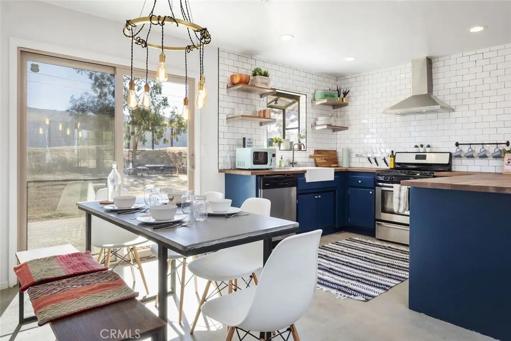 a kitchen with stainless steel appliances granite countertop a sink and a stove