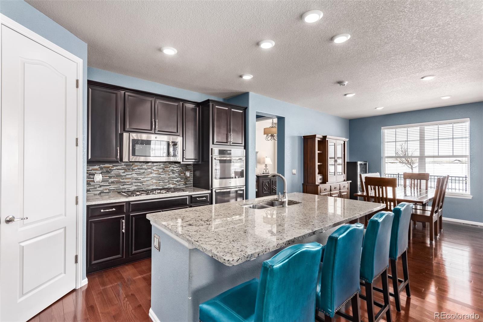 a kitchen with stainless steel appliances granite countertop a stove and a center island