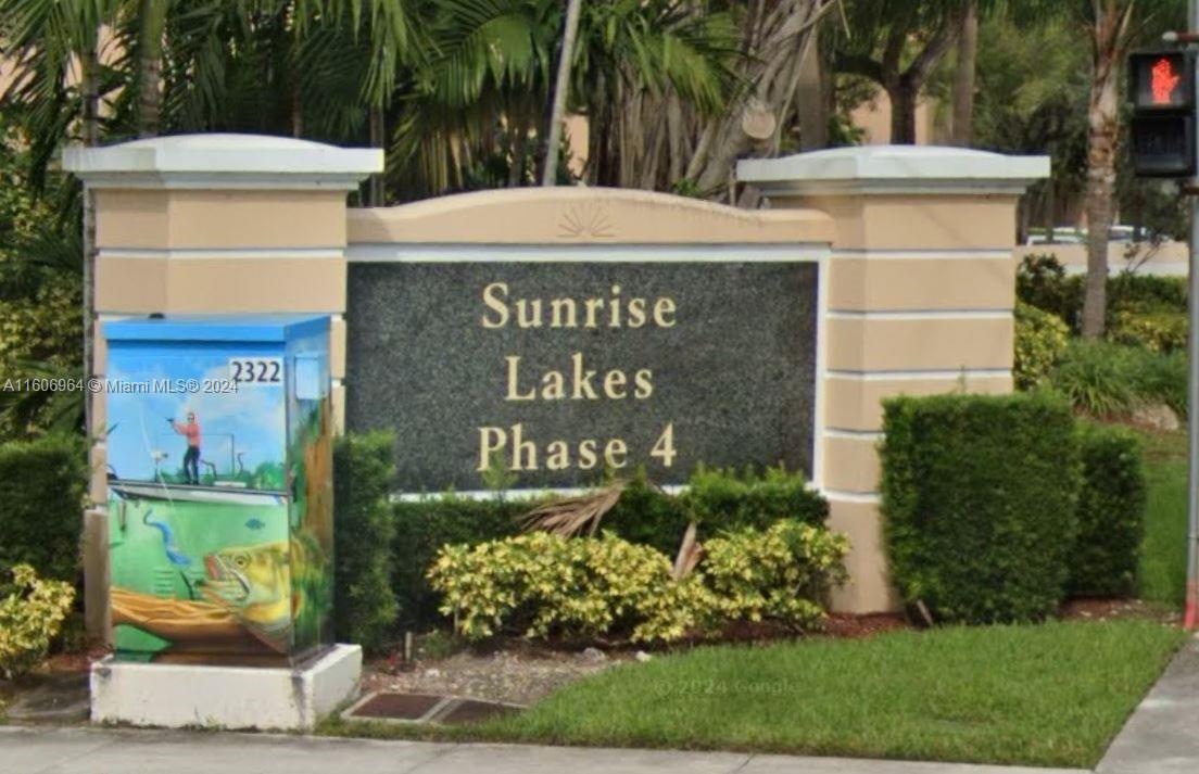 a view of outdoor space with sign board and garden