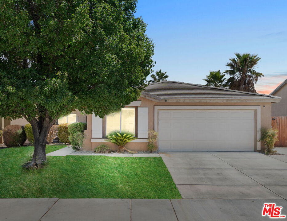 a front view of a house with a yard and a garage