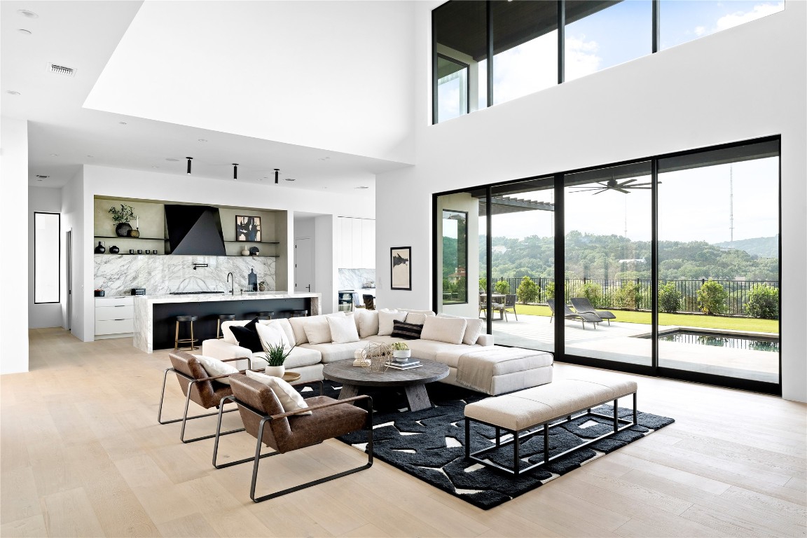 a living room with furniture fireplace and a large window