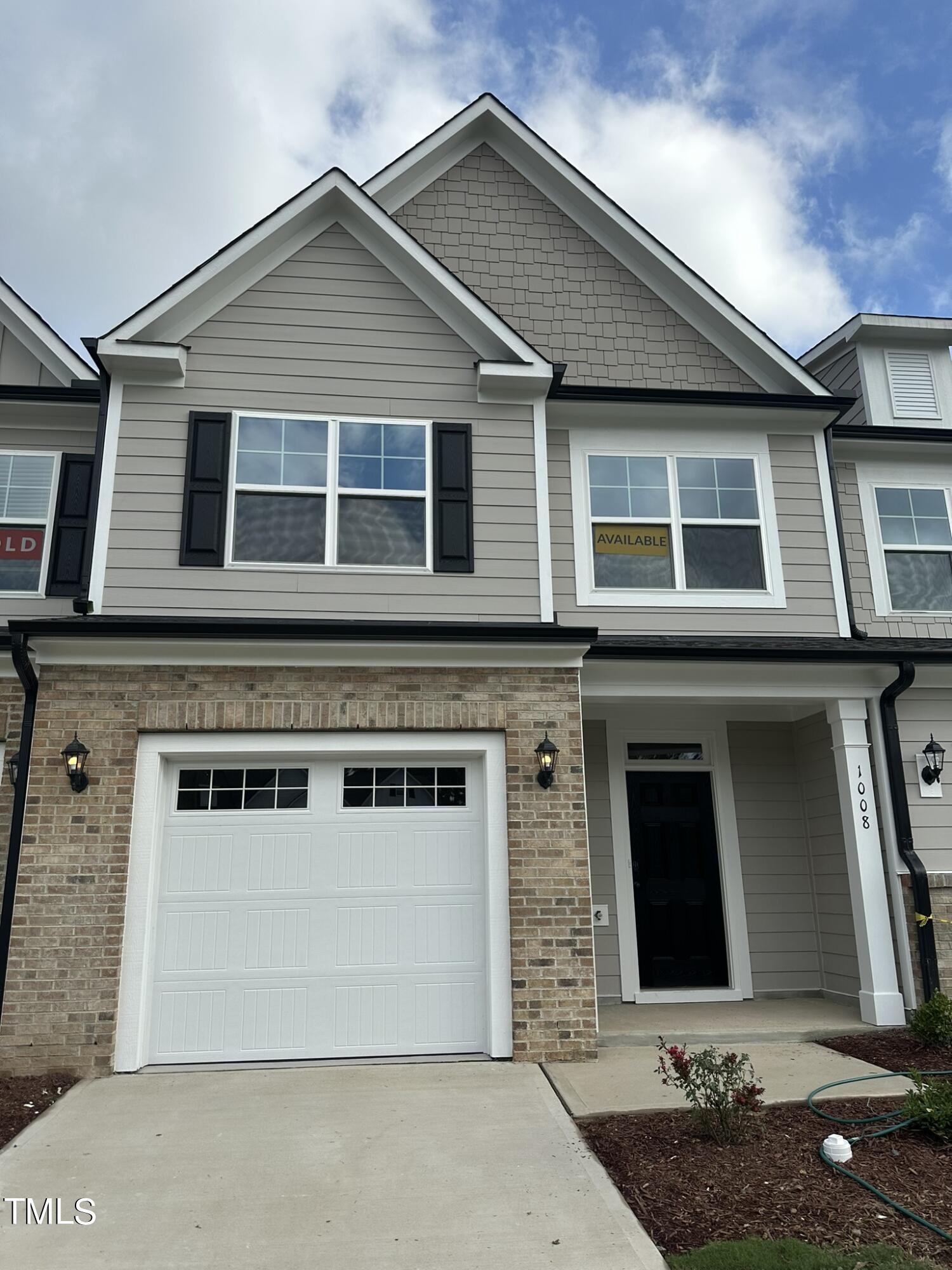 a front view of a house with garage