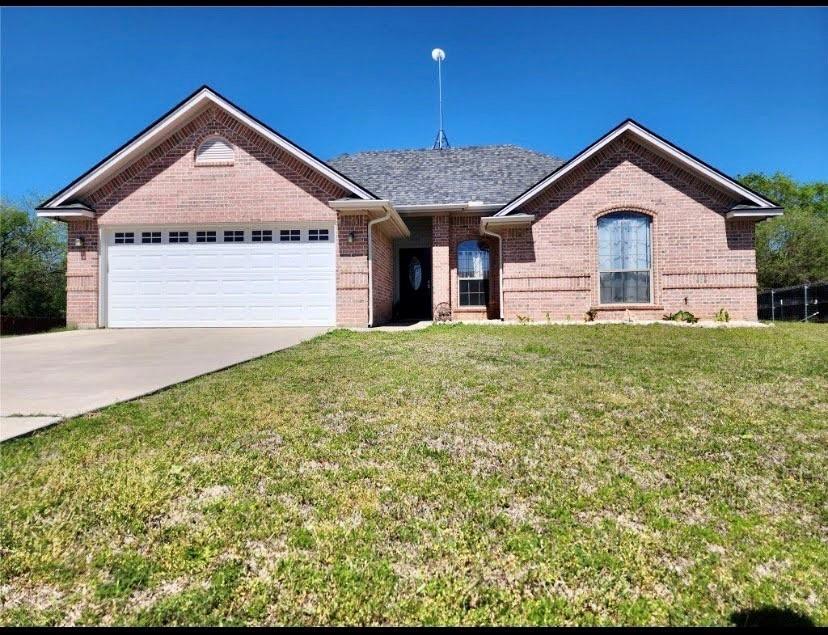 a front view of a house with yard and garage