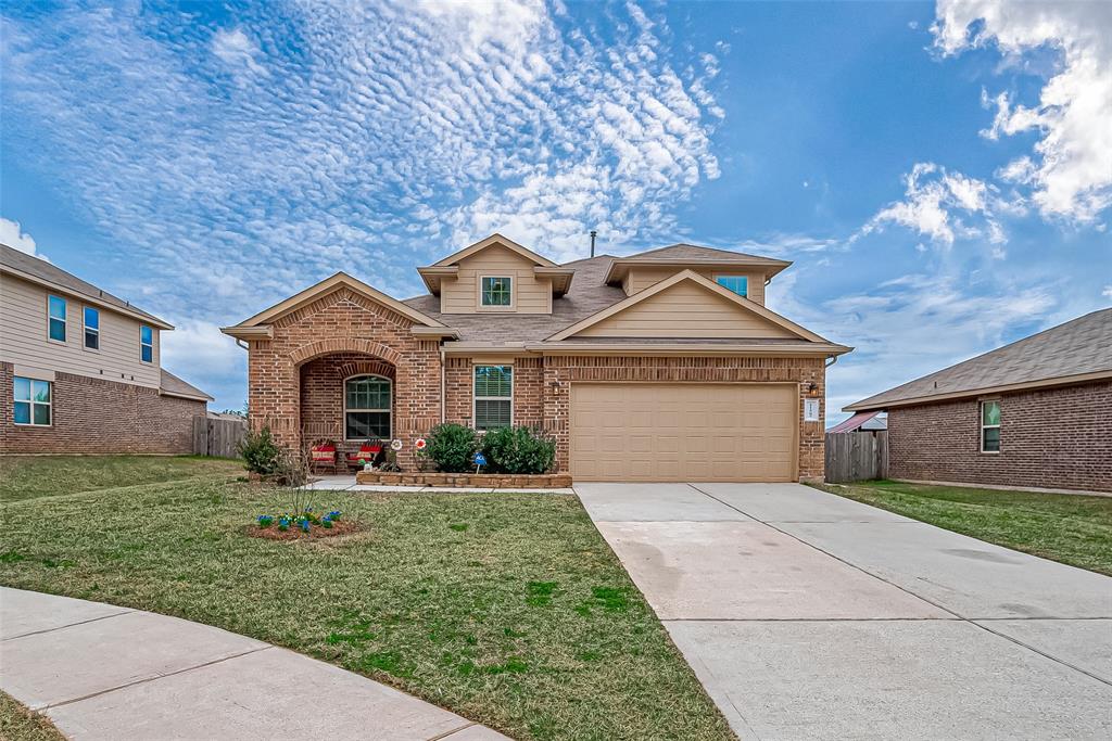 Charming brick home with inviting front porch, spacious driveway, and well-maintained lawn. Perfect for comfortable living.