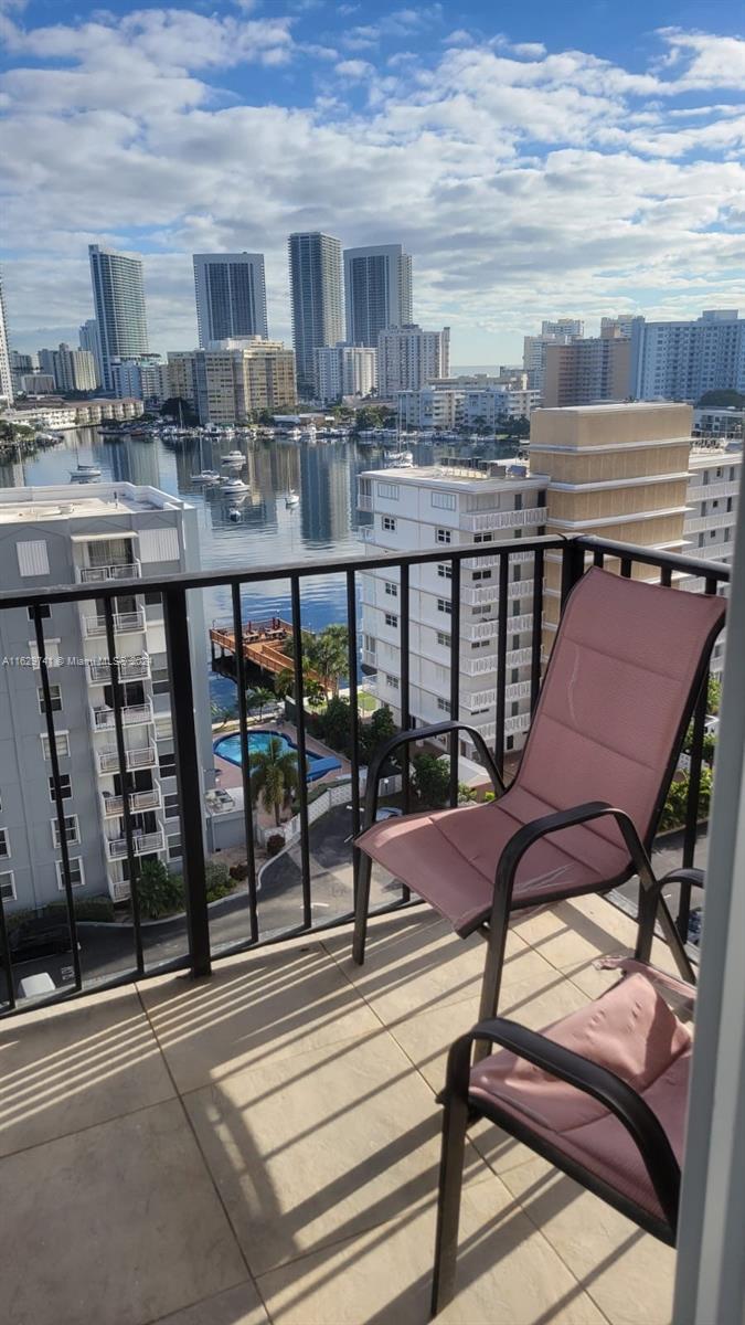 a view of a chairs and table in the balcony