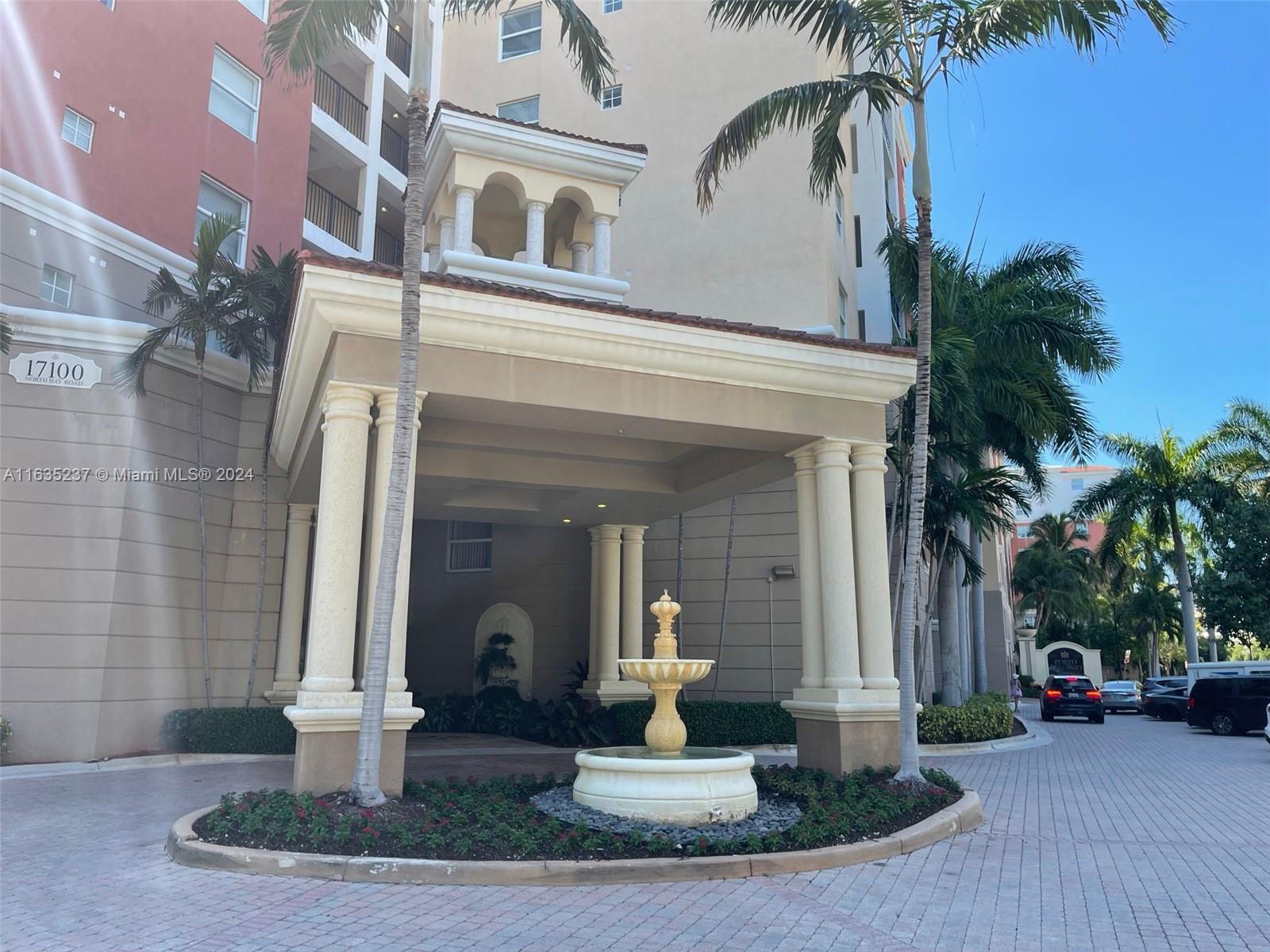 a front view of a house with a fountain