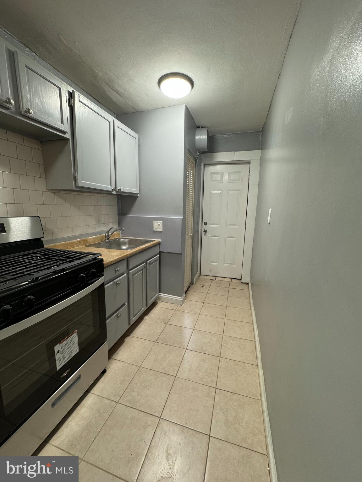 a kitchen with a stove and a sink