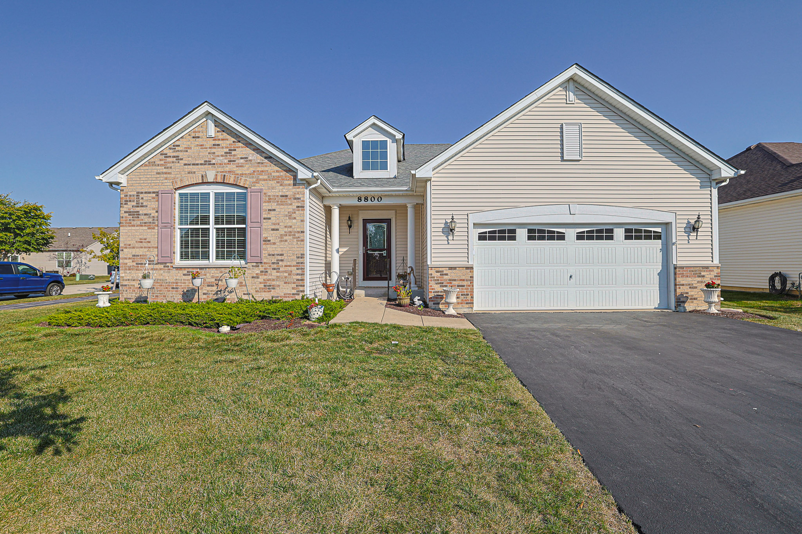 a front view of a house with a yard and garage