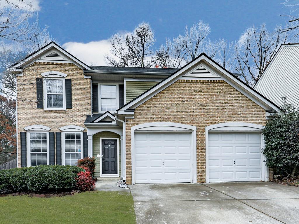 a front view of a house with a yard