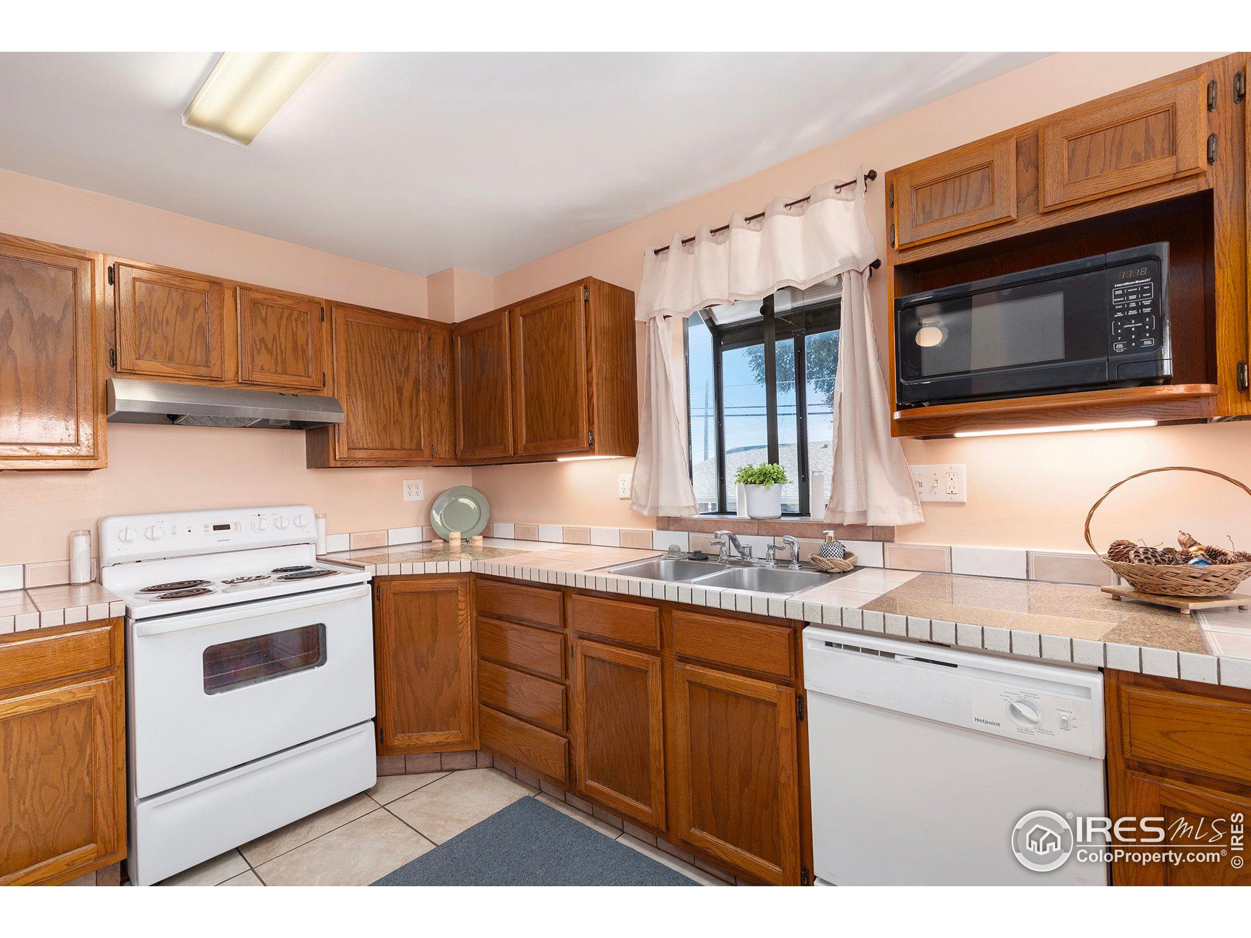 a kitchen with stainless steel appliances granite countertop a sink stove and microwave