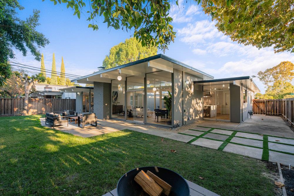 a view of a house with backyard porch and sitting area