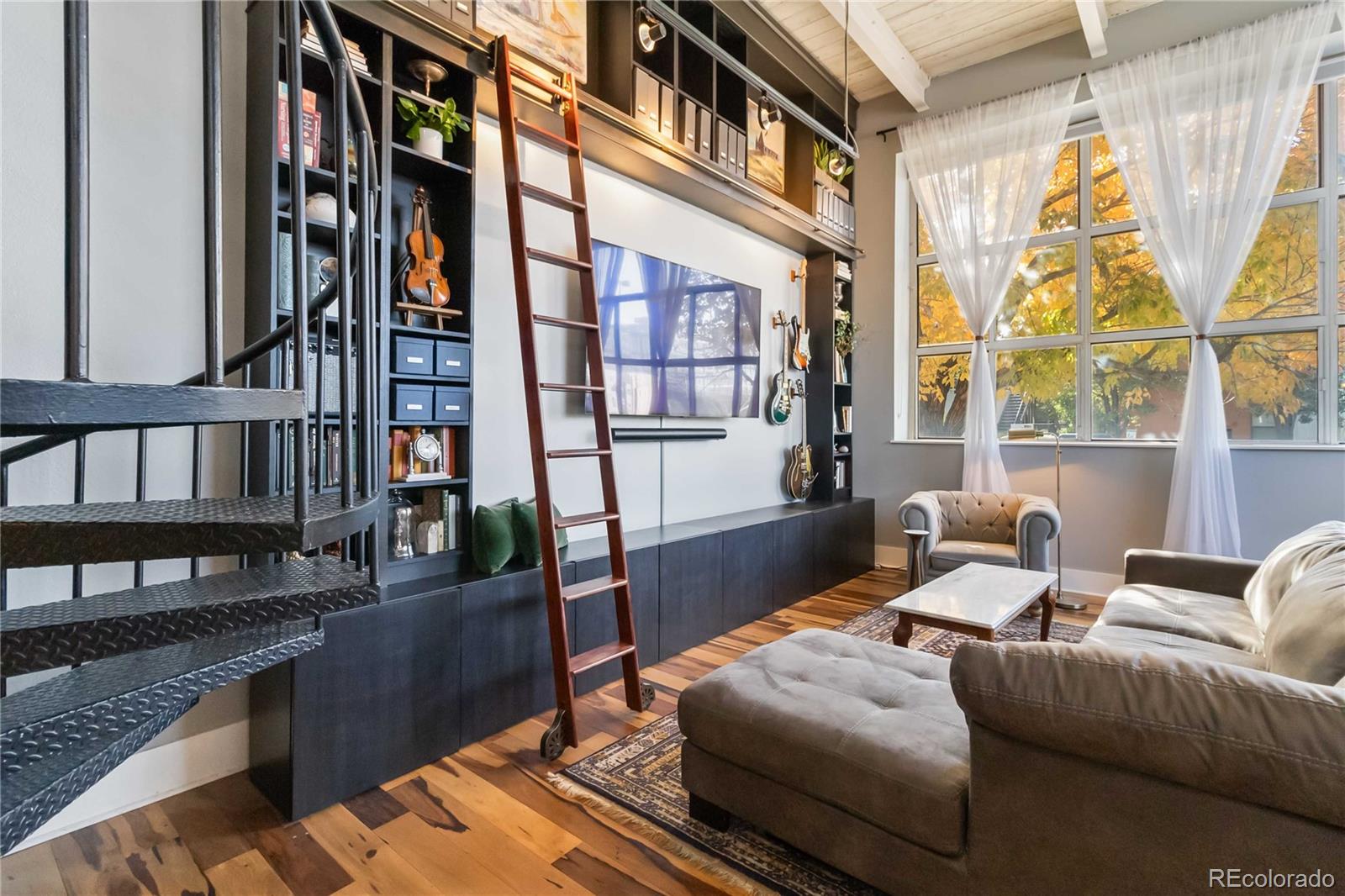 a living room with furniture next to a window