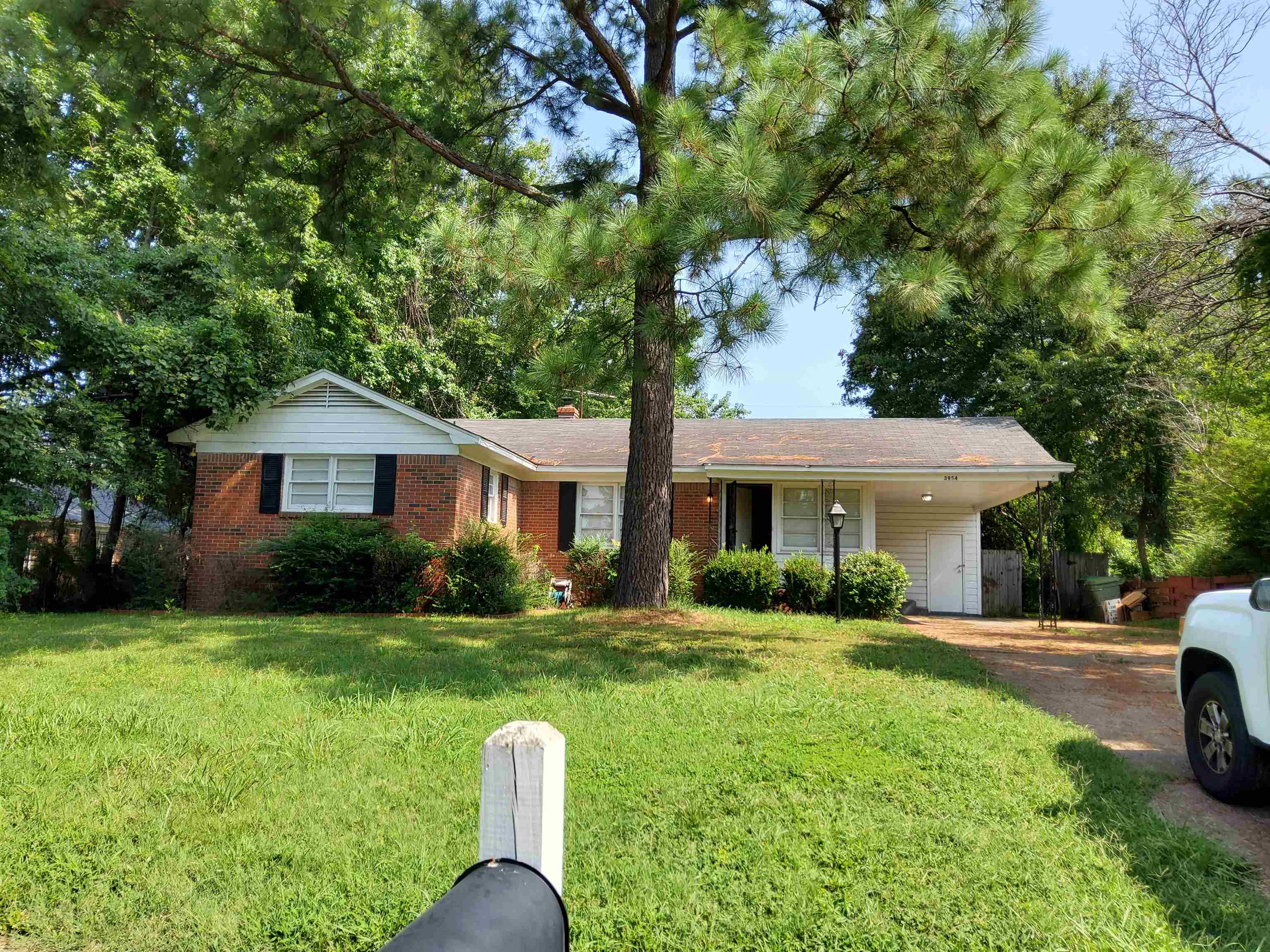 a front view of a house with yard porch and green space