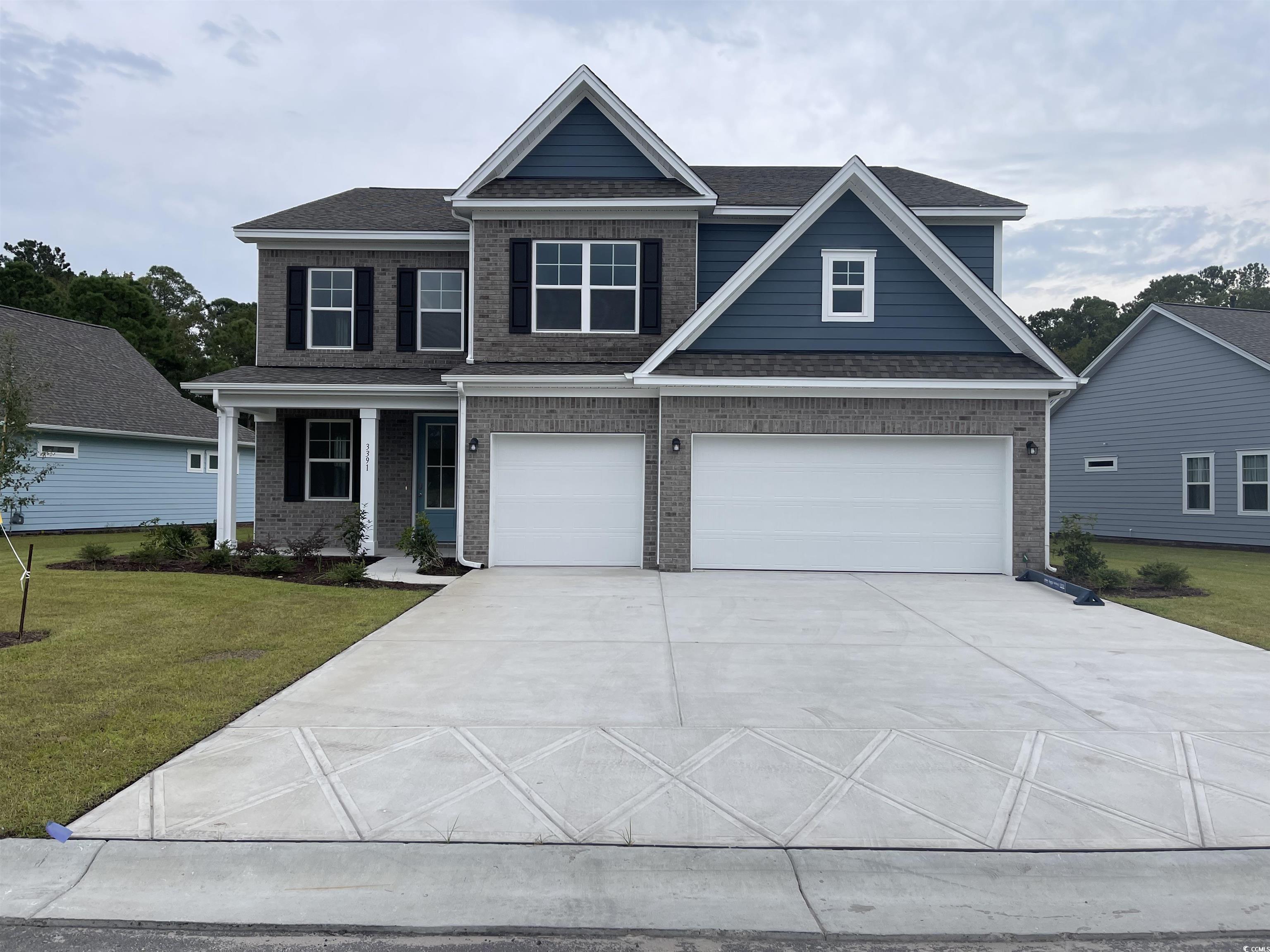 Craftsman-style house with a front yard and a gara