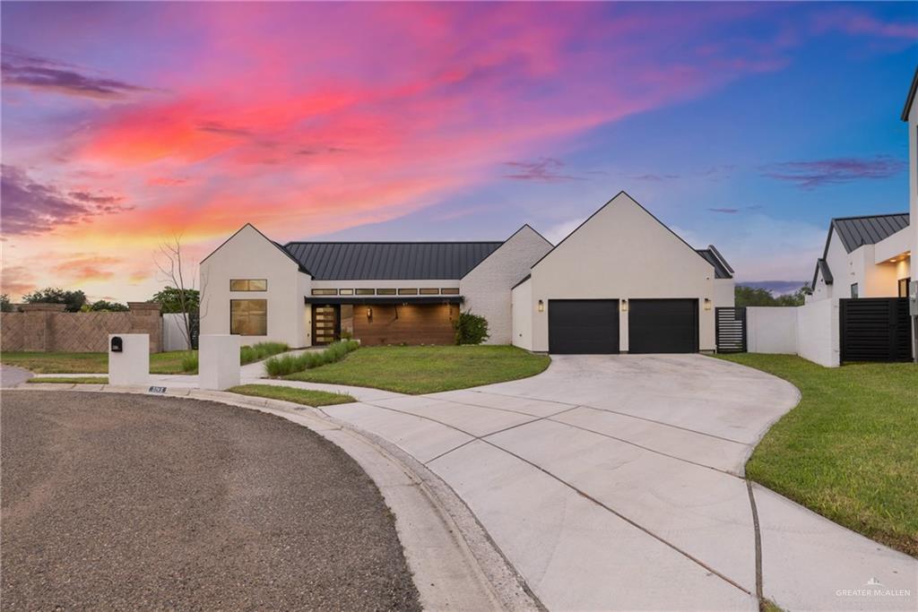 Modern inspired farmhouse with a garage and a yard