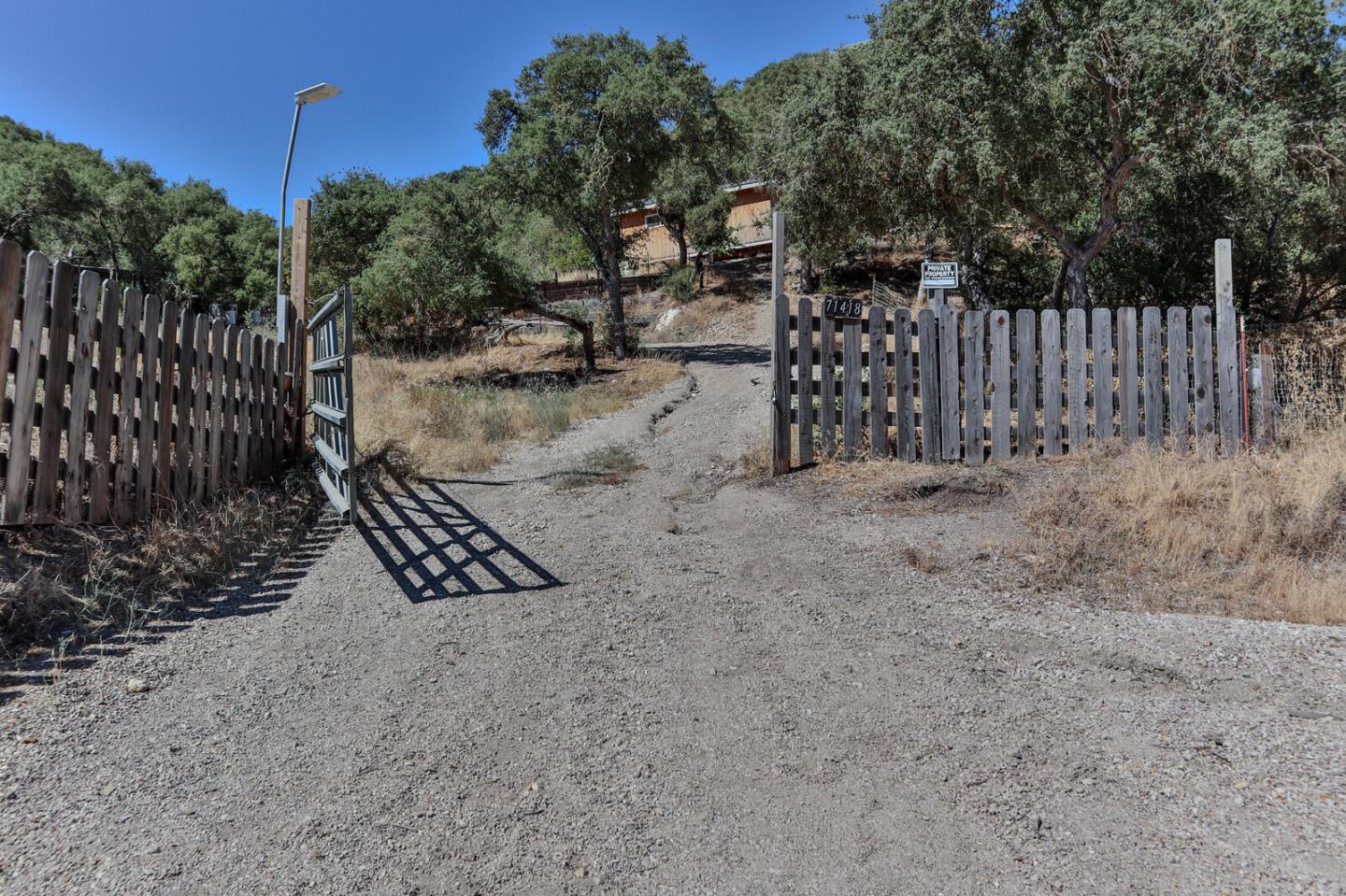 a view of a backyard with wooden fence