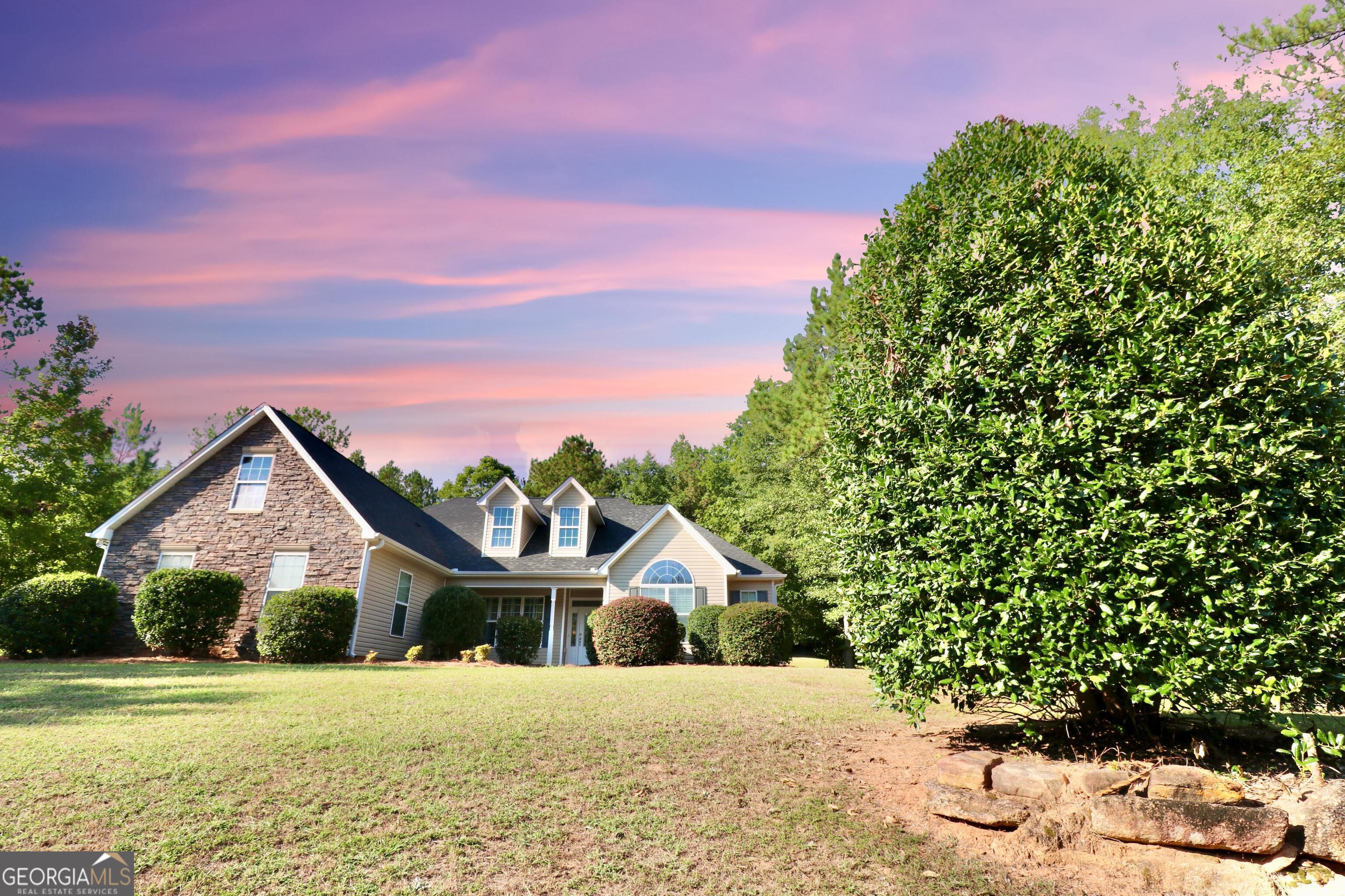 a front view of a house with a yard