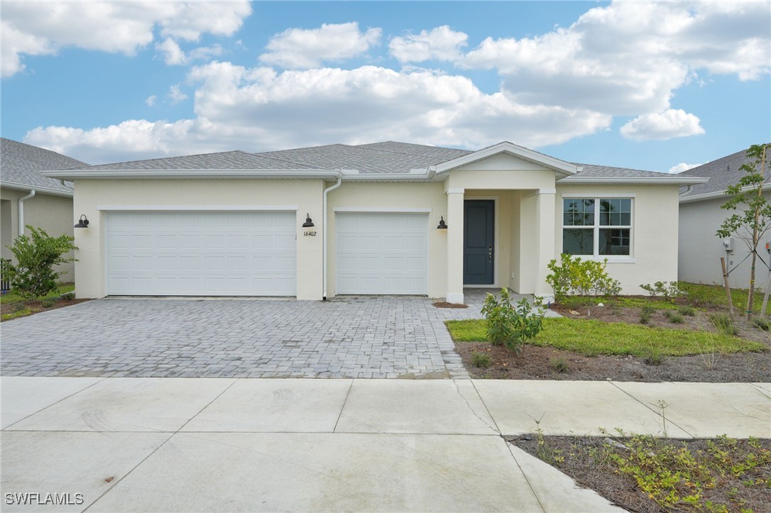 a view of a house with a yard and garage