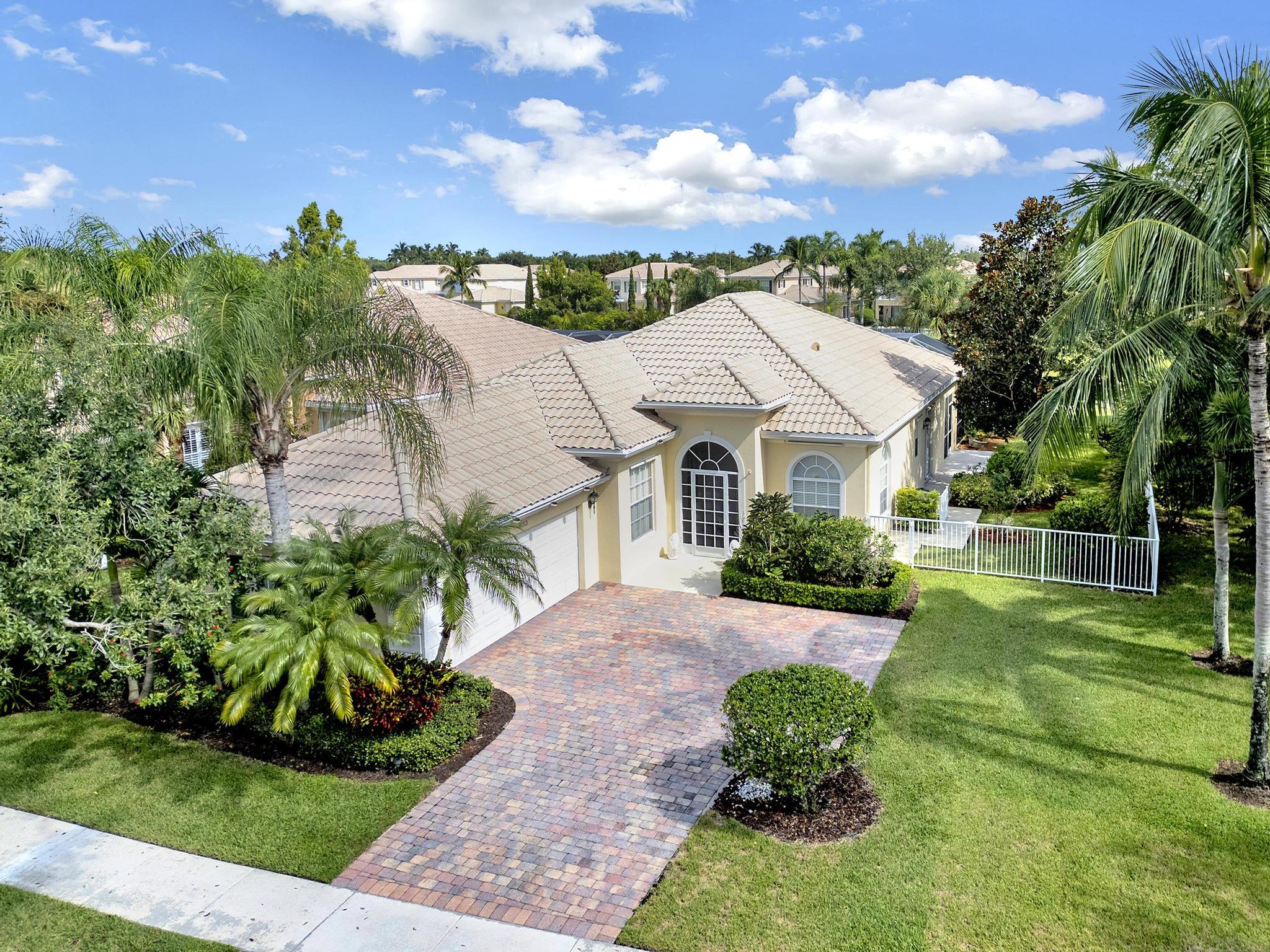 a aerial view of a house with a yard and potted plants