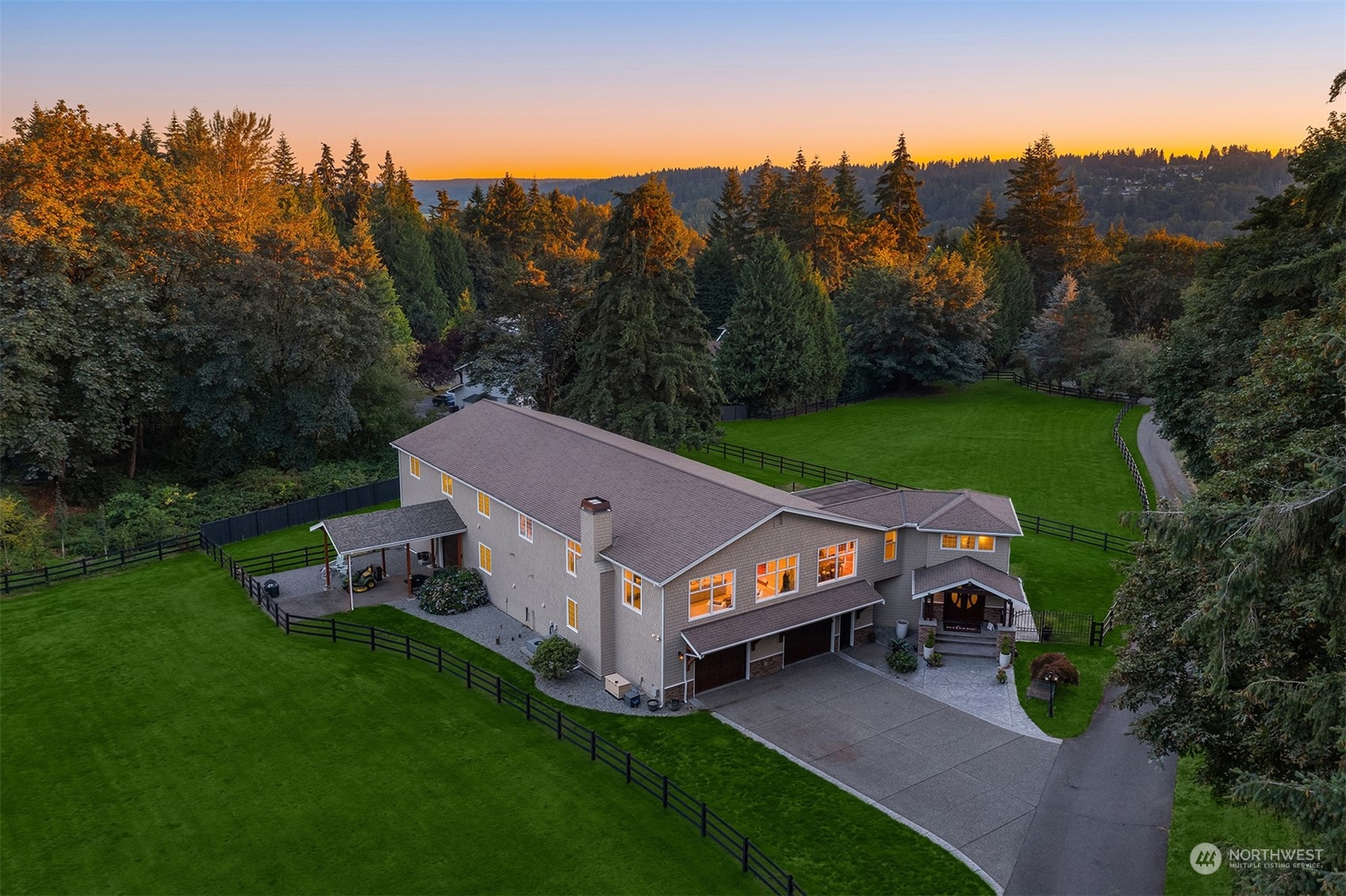 a view of a house with a big yard and large trees