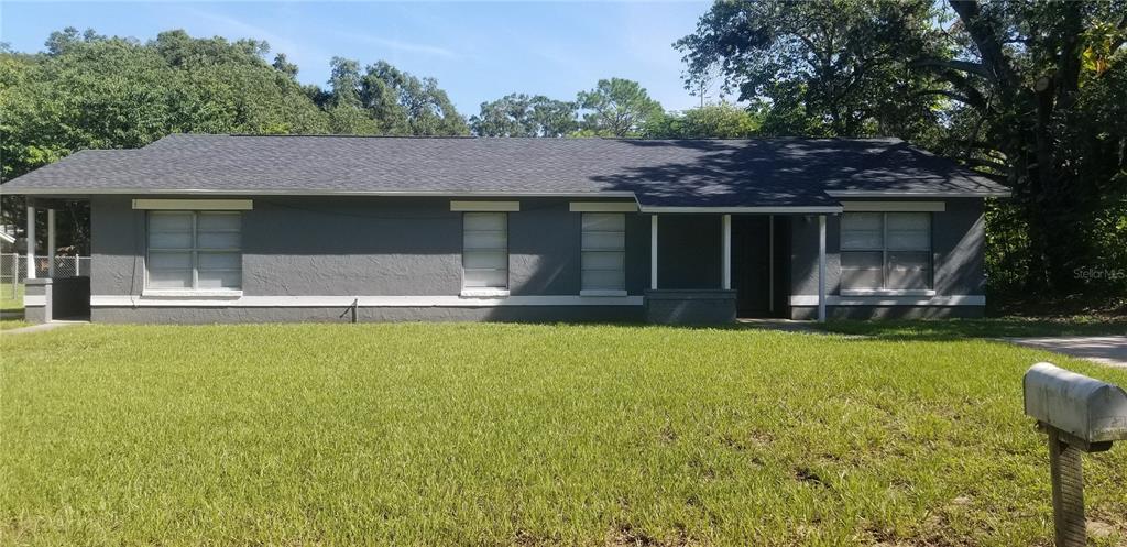 a front view of house with yard and outdoor seating