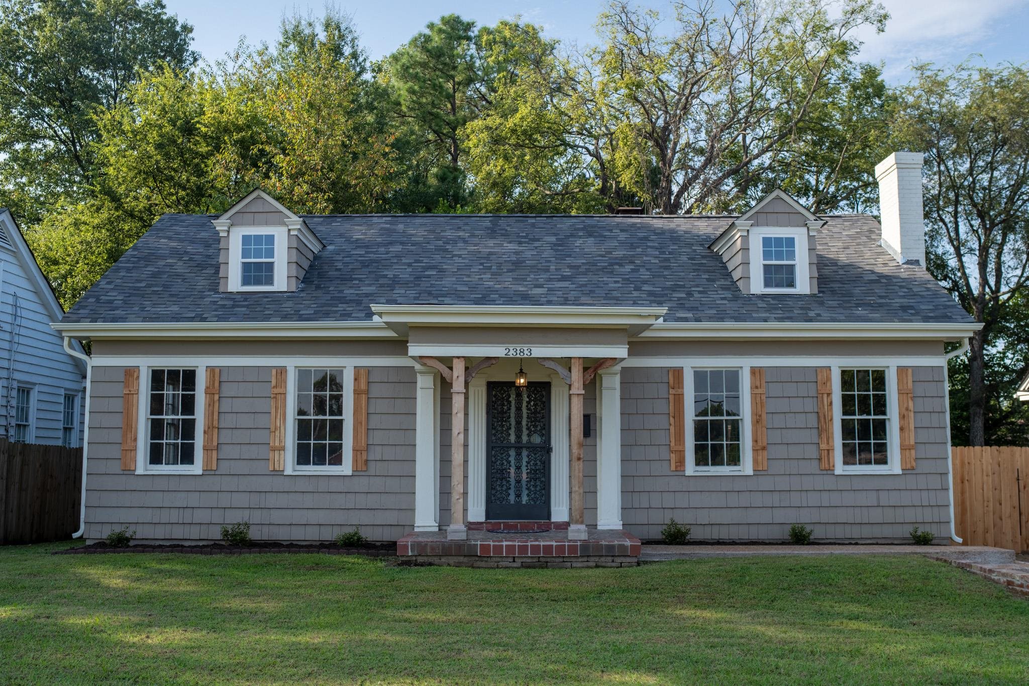 a front view of a house with a garden