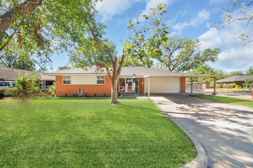 a front view of a house with a yard and a garage