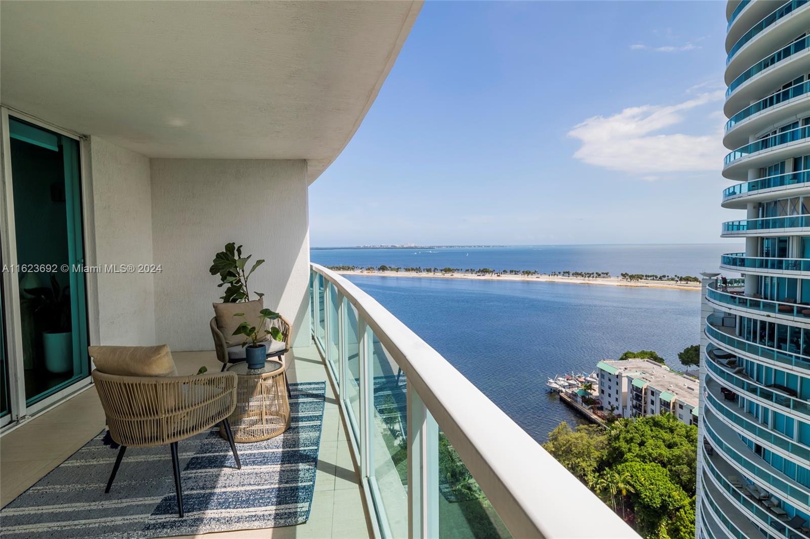 a balcony with wooden floor and furniture