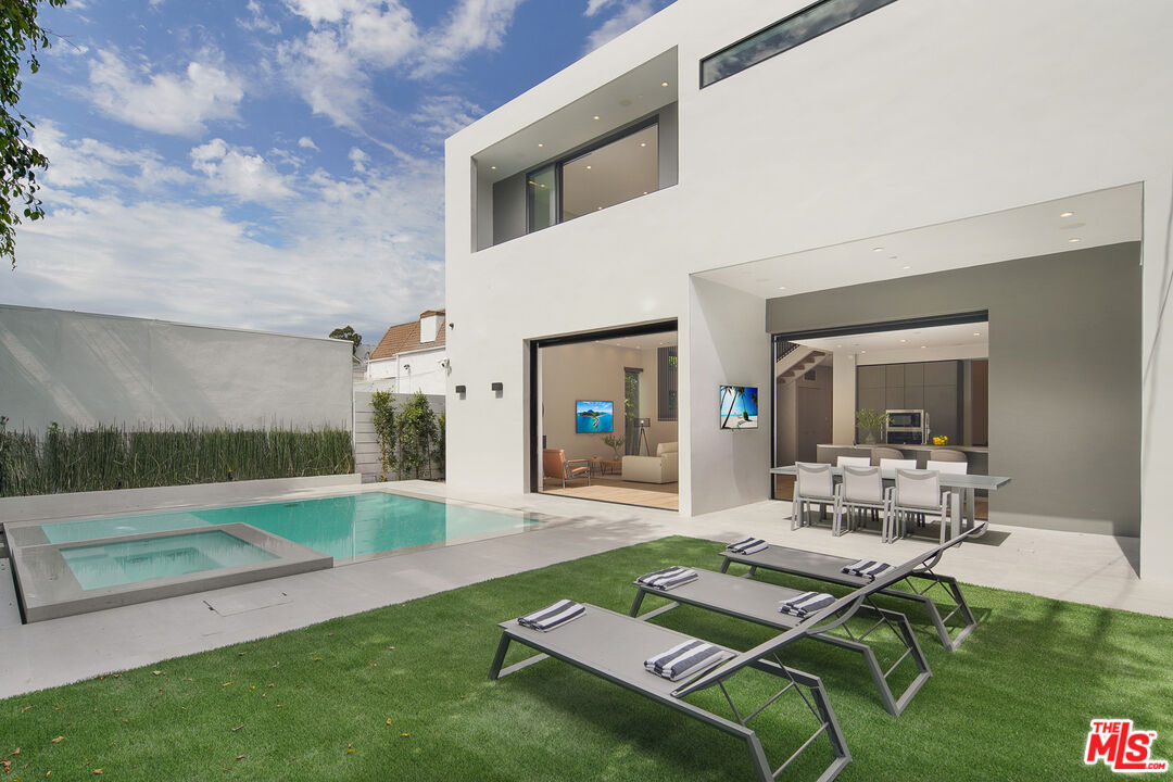 a living room with patio furniture and a large window