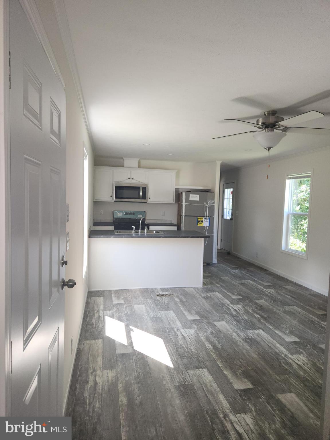 a view of kitchen with cabinets and wooden floor