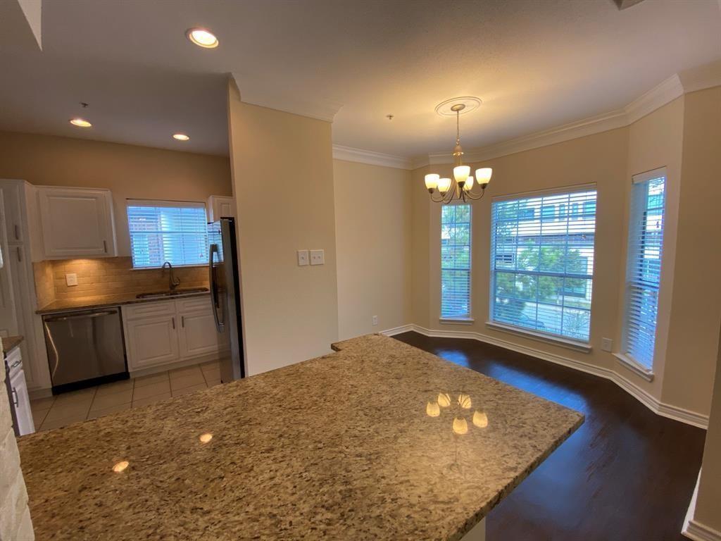 a view of a room with a ceiling fan and window