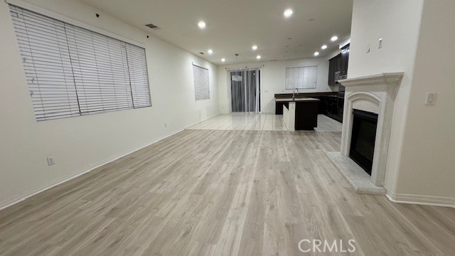 a view of kitchen with granite countertop cabinets and wooden floor