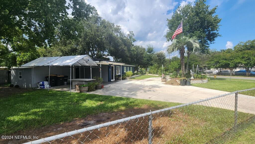 a front view of a house with yard patio and green space