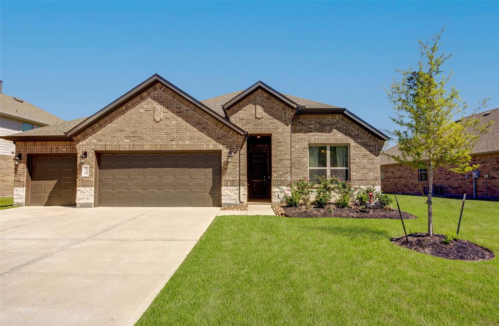 a front view of a house with a garden and yard