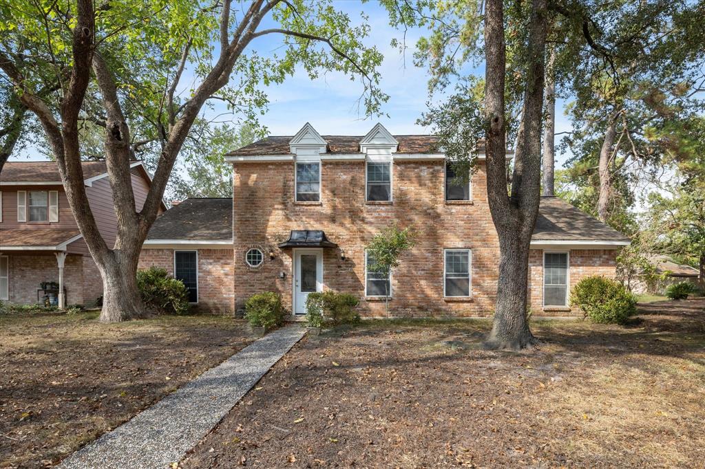 front view of a house with a tree