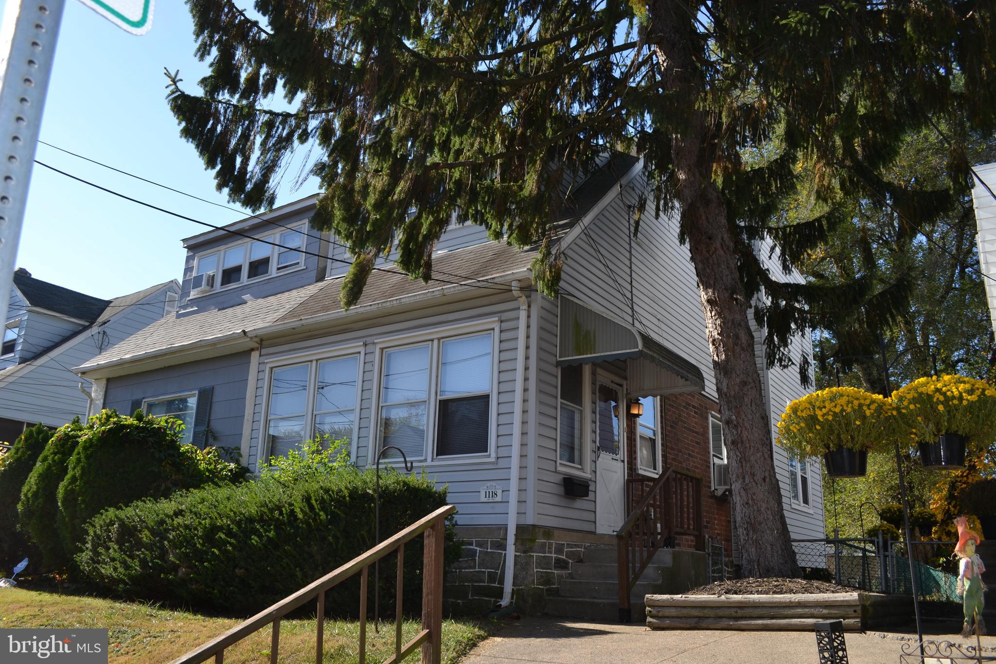 a front view of a house with plants