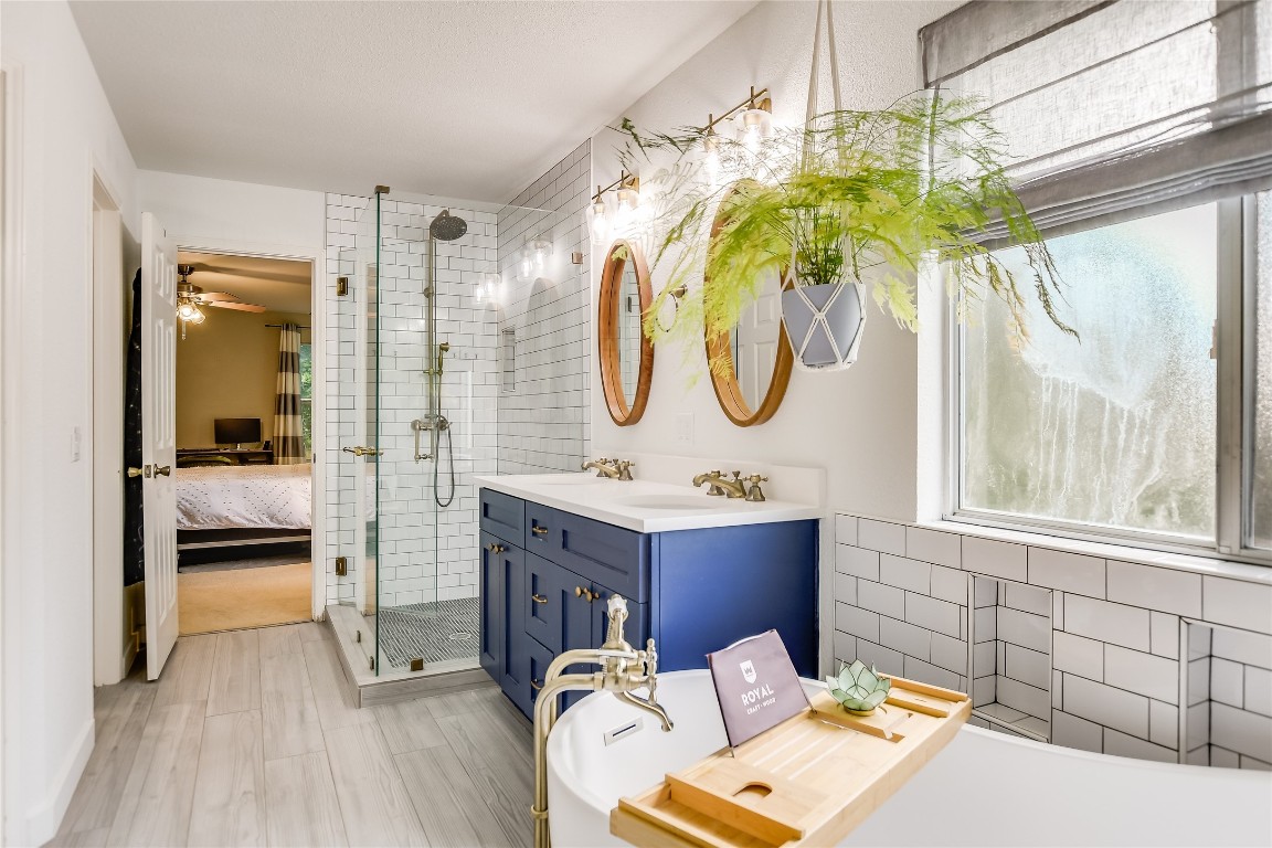 a bathroom with a sink a mirror and a shower