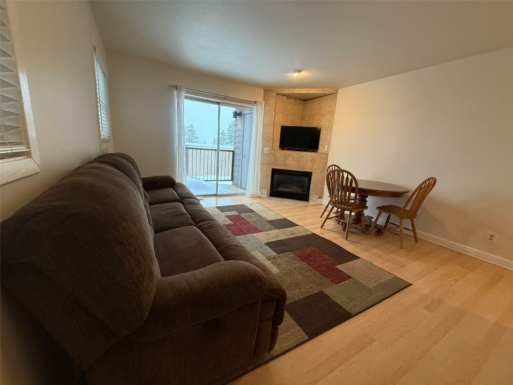 a living room with furniture a fireplace and a window