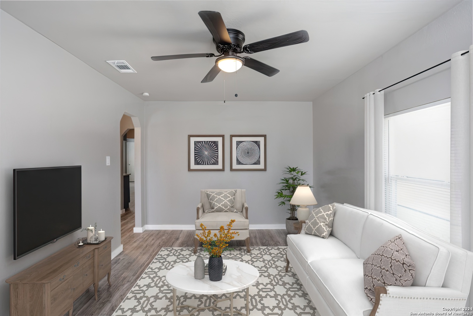 a living room with furniture and a flat screen tv