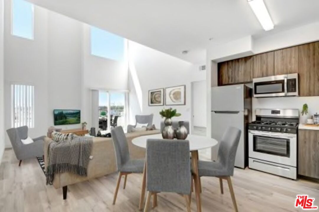 a dining room with furniture a window and kitchen view