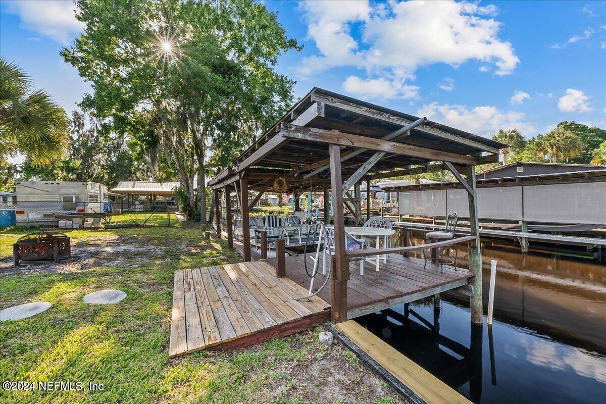 a view of a backyard with sitting area